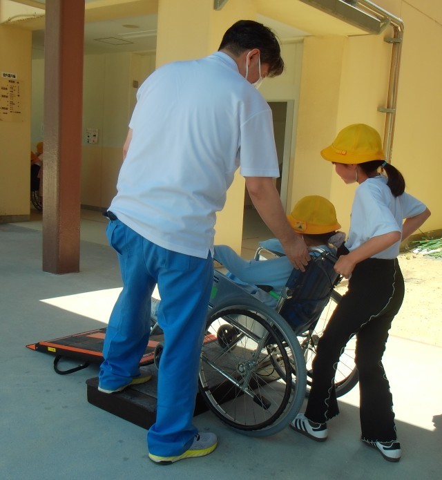 車いすの介助体験で段差をのぼる様子
